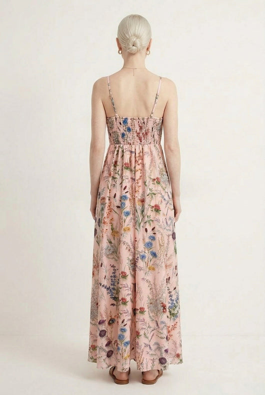 Woman wearing a rosewater pink floral print maxi dress with spaghetti straps